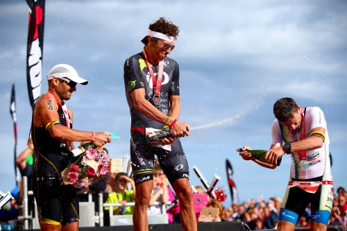PEMBROKE, WALES - SEPTEMBER 13: Gold medalist Jesse Thomas of the USA (C), Silver medalist Andrej Vistica of Croatia (L) and Bronze medalist Markus Thomschke of Germany (R) celebrate after winning Ironman Wales on September 13, 2015 in Pembroke, Wales. (Photo by Jordan Mansfield/Getty Images for Ironman) *** Local Caption *** Jesse Thomas; Andrej Vistica; Markus Thomschke